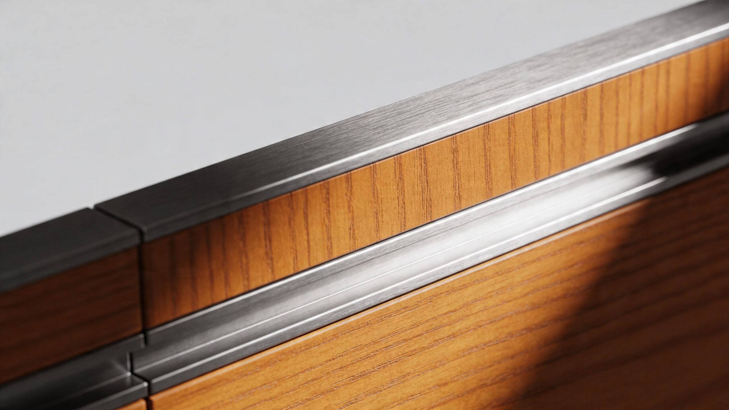 A close-up shot of modern wooden cabinetry featuring sleek metallic handle trim and contemporary design details.