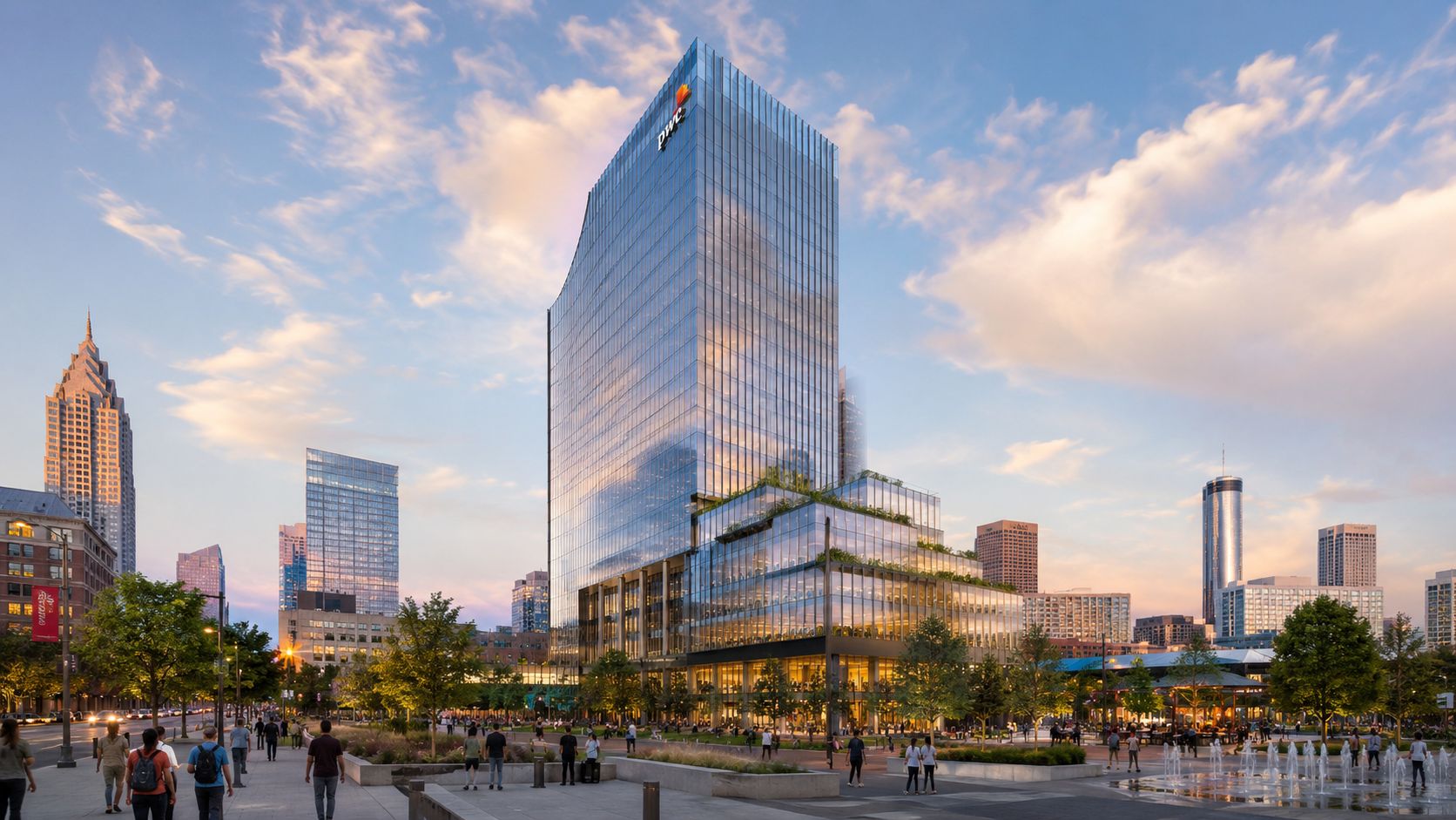 A modern glass skyscraper with a PwC sign stands in a city park at sunset in Atlanta.