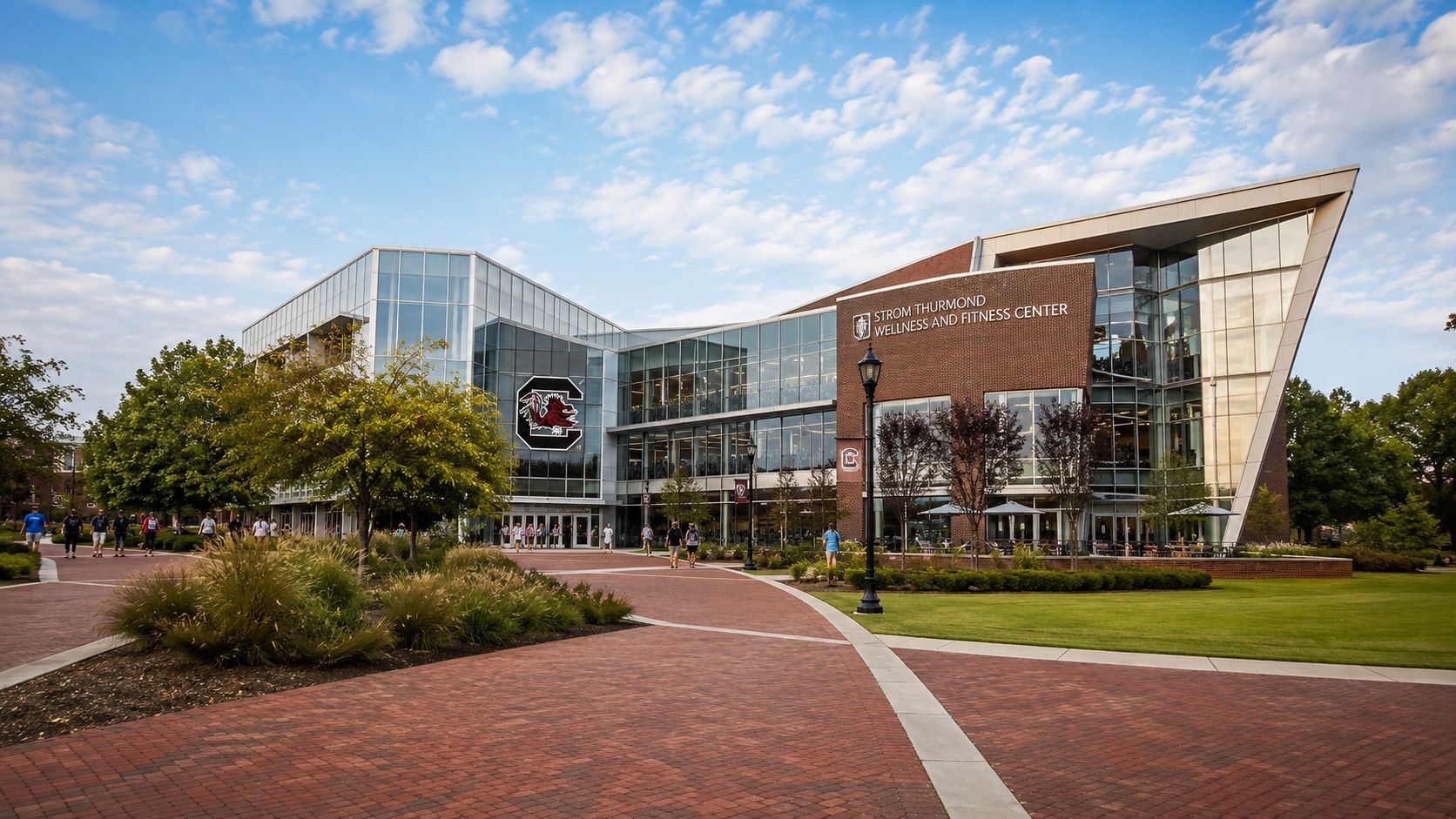 The modern glass and brick Strom Thurmond Wellness and Fitness Center building on a sunny college campus.