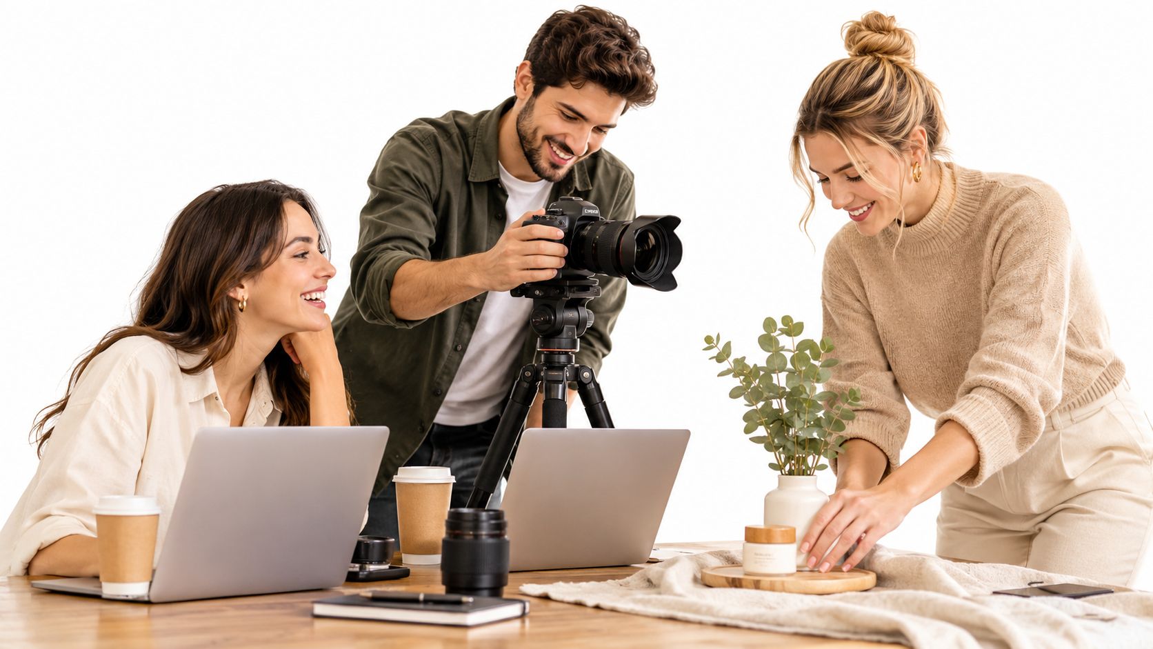 A diverse creative team collaborating on a commercial product photoshoot with a camera, laptop, and props.